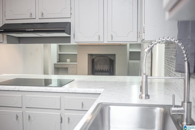 kitchen featuring white cabinetry and black electric cooktop