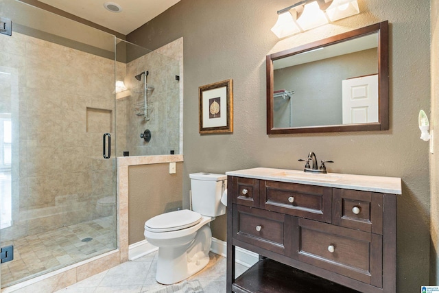 bathroom with vanity, toilet, tile patterned floors, and walk in shower