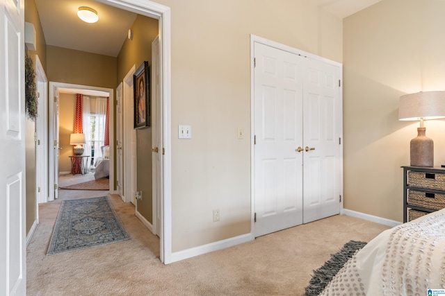 bedroom with light carpet and a closet