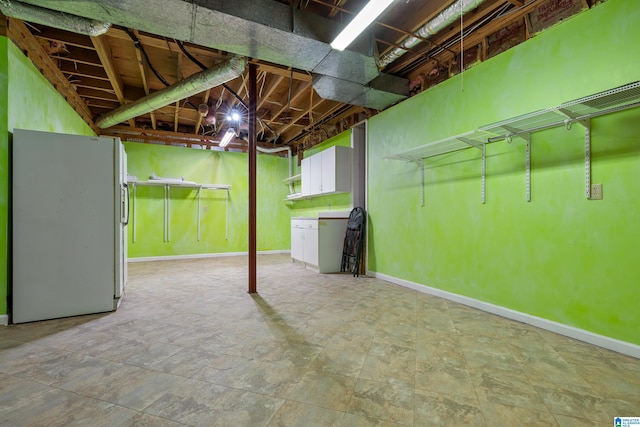 basement featuring stainless steel fridge