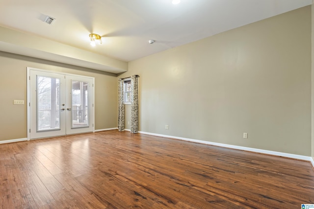 spare room featuring wood-type flooring and french doors