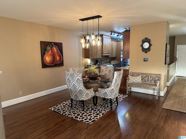 dining space with dark hardwood / wood-style flooring