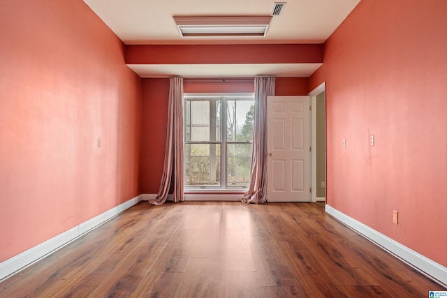 spare room with wood-type flooring