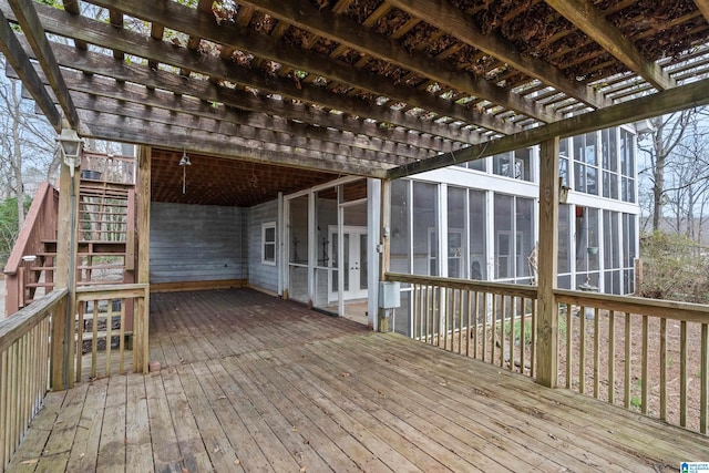 wooden terrace with a sunroom and a pergola