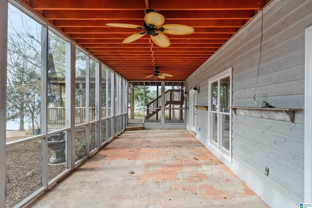 unfurnished sunroom featuring ceiling fan