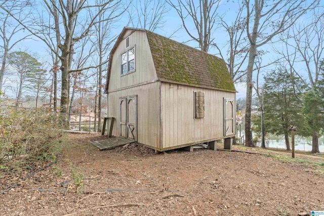 view of outbuilding with a water view