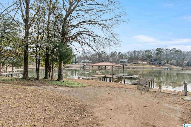 view of yard featuring a water view and a boat dock