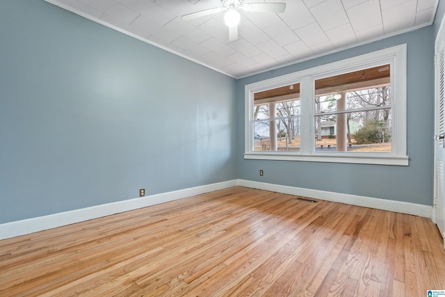 empty room featuring ornamental molding, ceiling fan, and light hardwood / wood-style floors