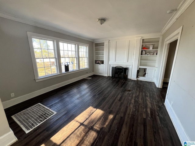 unfurnished living room featuring built in shelves, ornamental molding, and dark hardwood / wood-style floors