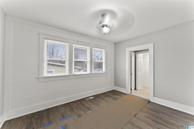 unfurnished room with wood-type flooring