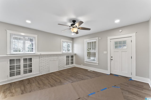 foyer with dark hardwood / wood-style flooring and ceiling fan