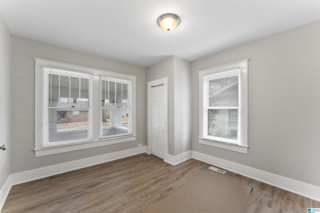 unfurnished room with hardwood / wood-style floors