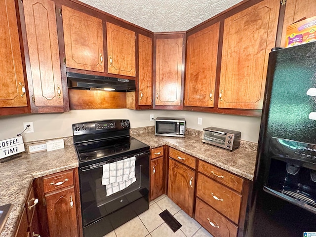 kitchen featuring stone counters, light tile patterned floors, a textured ceiling, and black appliances