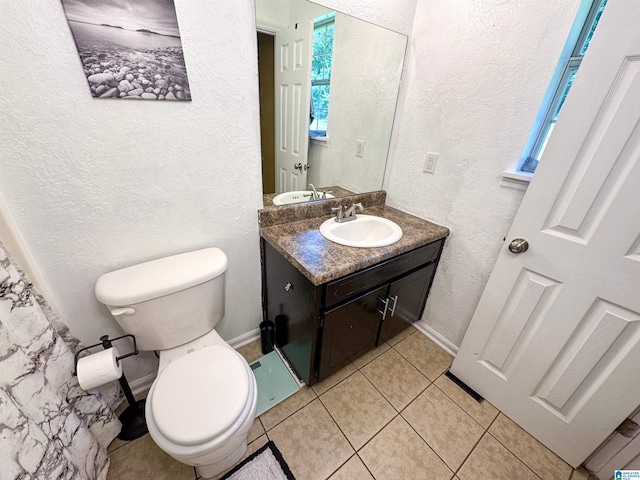 bathroom featuring vanity, toilet, and tile patterned flooring