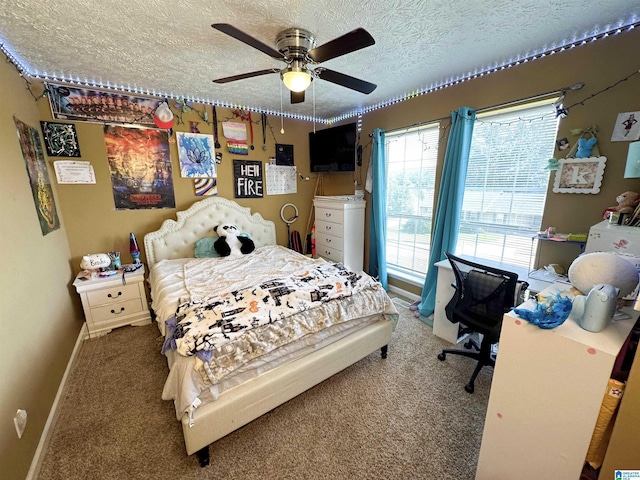 carpeted bedroom featuring ceiling fan and a textured ceiling