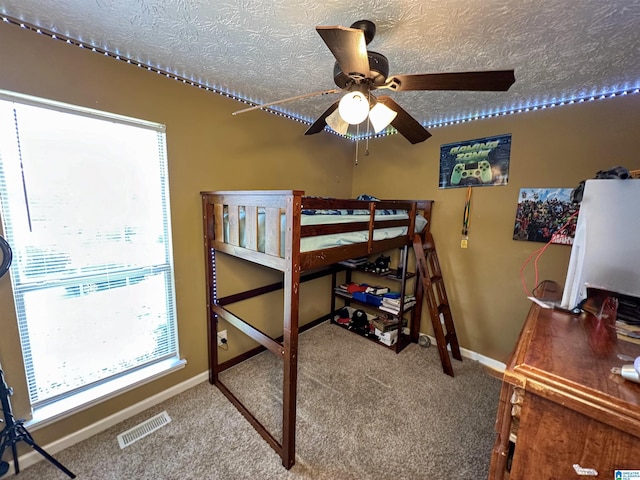 carpeted bedroom featuring a textured ceiling