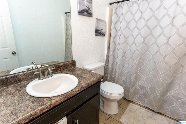 bathroom featuring a shower with curtain, vanity, toilet, and tile patterned flooring