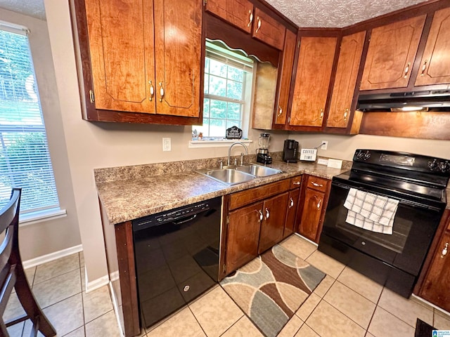 kitchen with light tile patterned flooring, sink, a textured ceiling, and black appliances