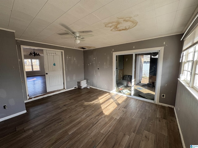 unfurnished living room featuring crown molding, ceiling fan, and dark hardwood / wood-style flooring