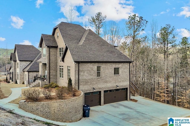 view of side of home featuring a garage