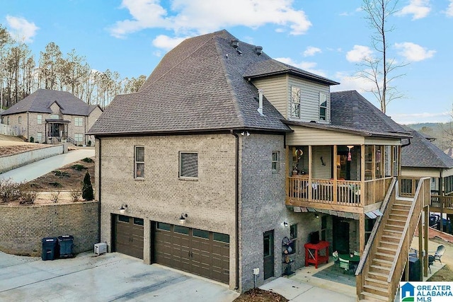 back of house featuring a garage