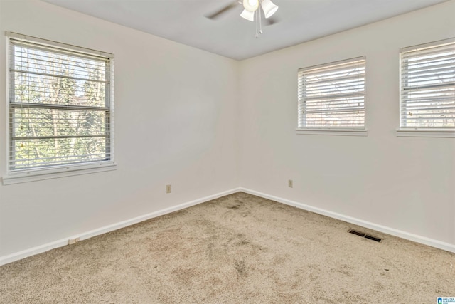 carpeted spare room with ceiling fan