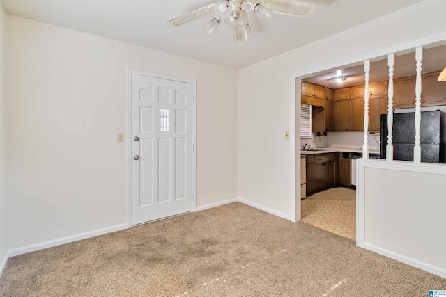 interior space featuring ceiling fan, sink, and light carpet