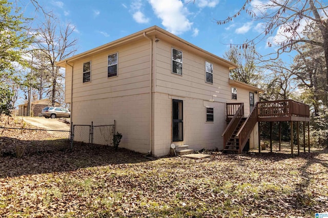 rear view of property with a wooden deck