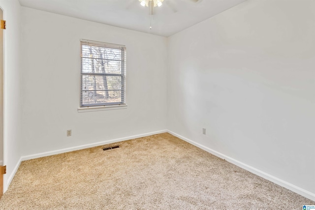 unfurnished room featuring ceiling fan and carpet