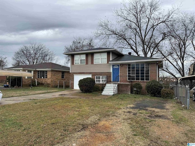 tri-level home with a garage and a front yard