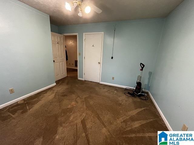 laundry area with ceiling fan and carpet flooring