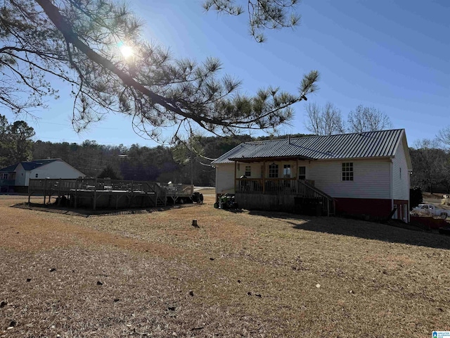 back of property with a pool side deck and a yard