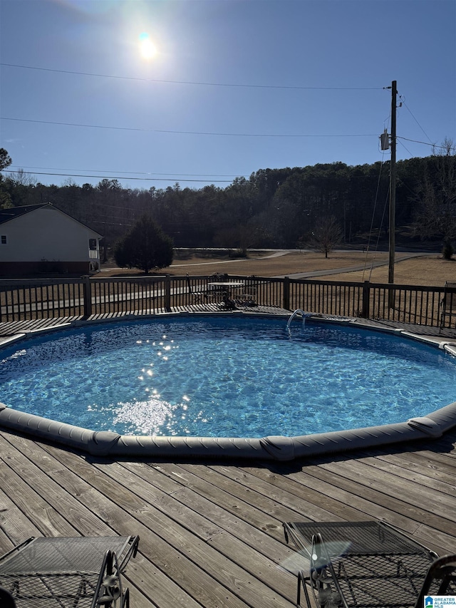 view of pool with a wooden deck