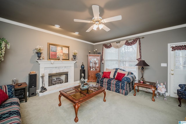 carpeted living room featuring ceiling fan, ornamental molding, and a premium fireplace