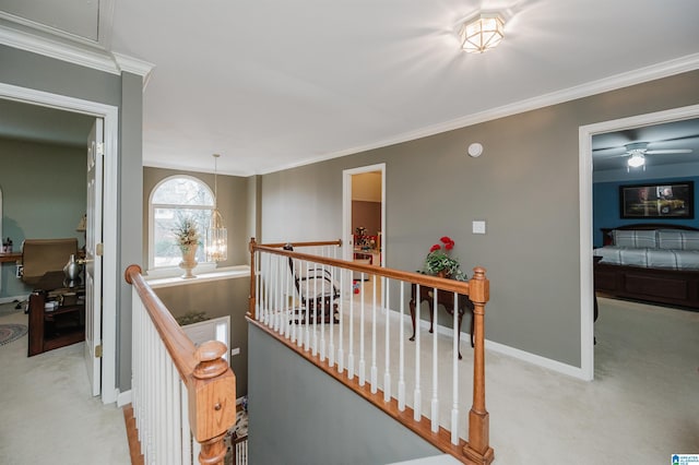 corridor featuring an inviting chandelier, crown molding, and light colored carpet