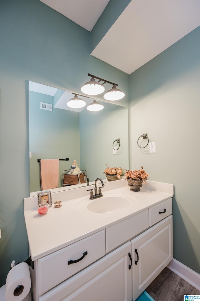 bathroom featuring vanity and hardwood / wood-style floors