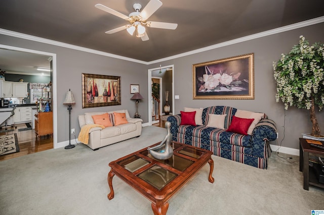 carpeted living room featuring crown molding and ceiling fan