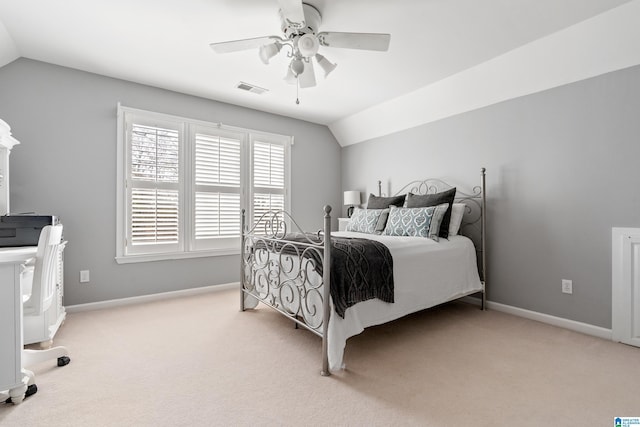 carpeted bedroom with vaulted ceiling and ceiling fan