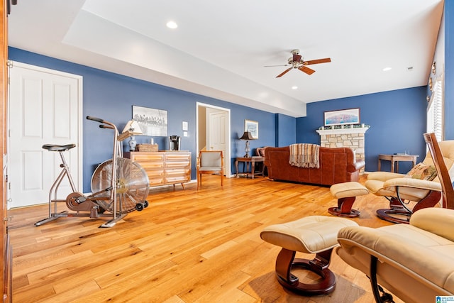 living room featuring ceiling fan and light wood-type flooring