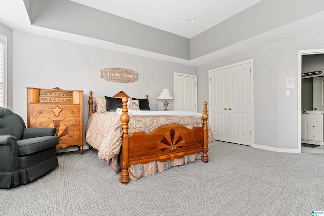 bedroom with carpet floors and a tray ceiling