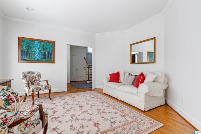 living room with hardwood / wood-style flooring and ornamental molding