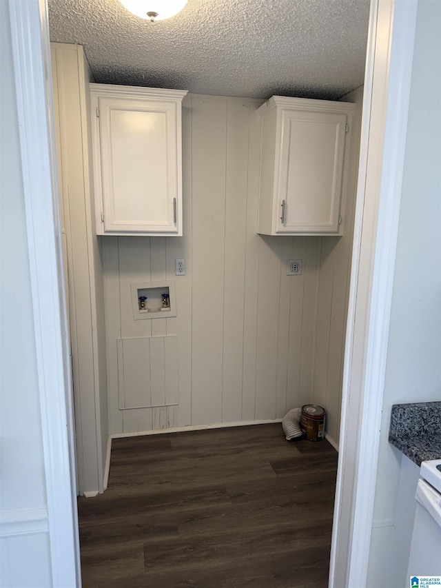 laundry room with washer hookup, dark hardwood / wood-style floors, cabinets, and a textured ceiling