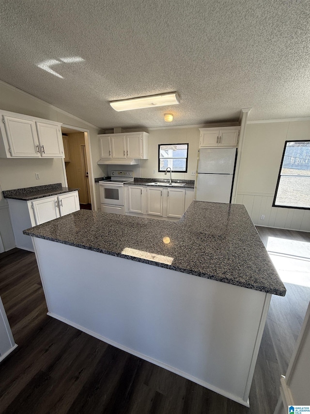 kitchen featuring white cabinetry, white appliances, dark hardwood / wood-style flooring, and a kitchen island