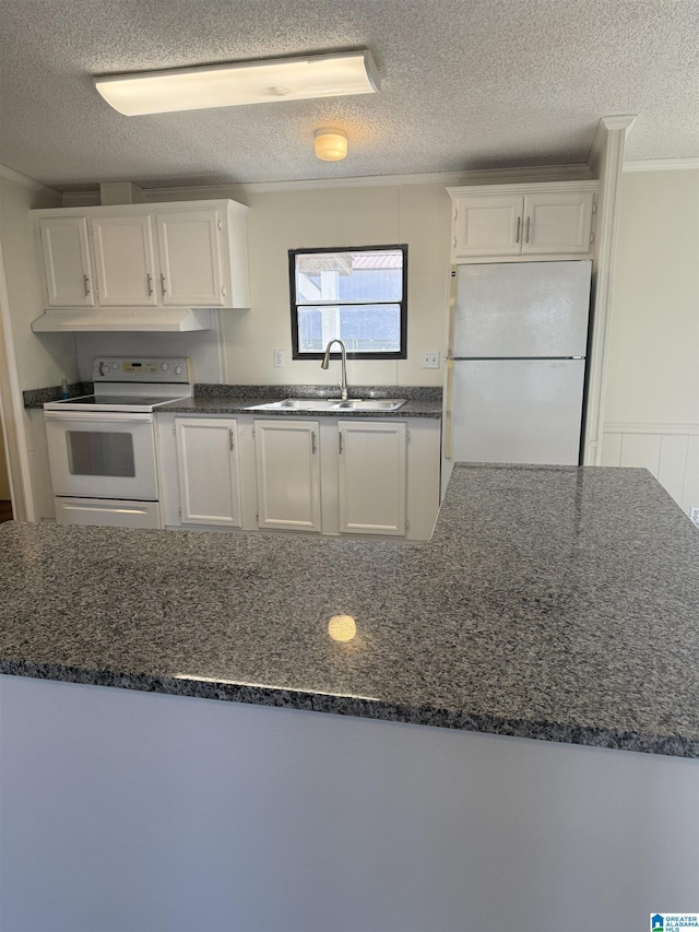 kitchen with sink, white appliances, dark stone countertops, a textured ceiling, and white cabinets