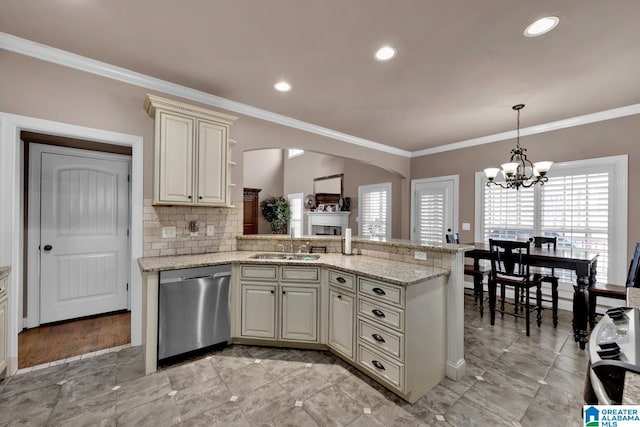 kitchen featuring decorative light fixtures, tasteful backsplash, dishwasher, light stone countertops, and cream cabinetry