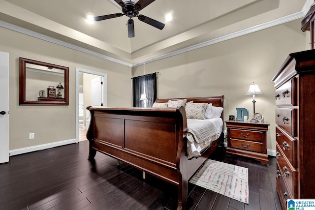 bedroom with crown molding, dark hardwood / wood-style floors, ceiling fan, and a tray ceiling