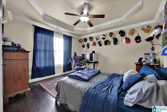 bedroom with crown molding, ceiling fan, dark hardwood / wood-style flooring, and a raised ceiling