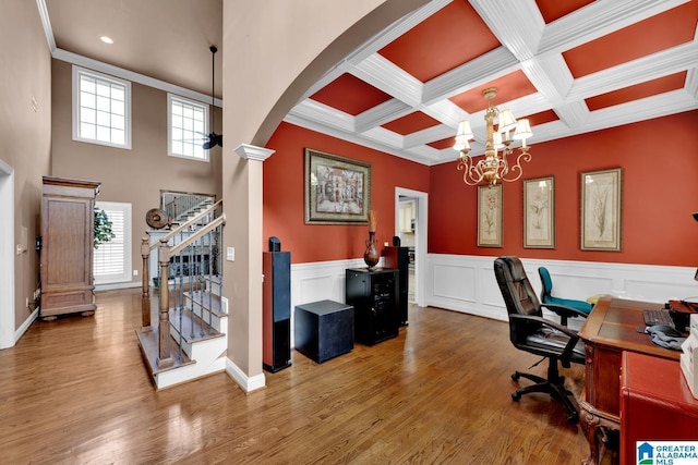 home office featuring coffered ceiling, a notable chandelier, hardwood / wood-style flooring, beam ceiling, and decorative columns