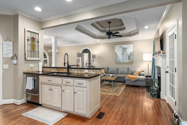 kitchen with sink, decorative columns, ceiling fan, hardwood / wood-style floors, and white cabinets