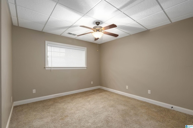 carpeted empty room featuring a paneled ceiling and ceiling fan